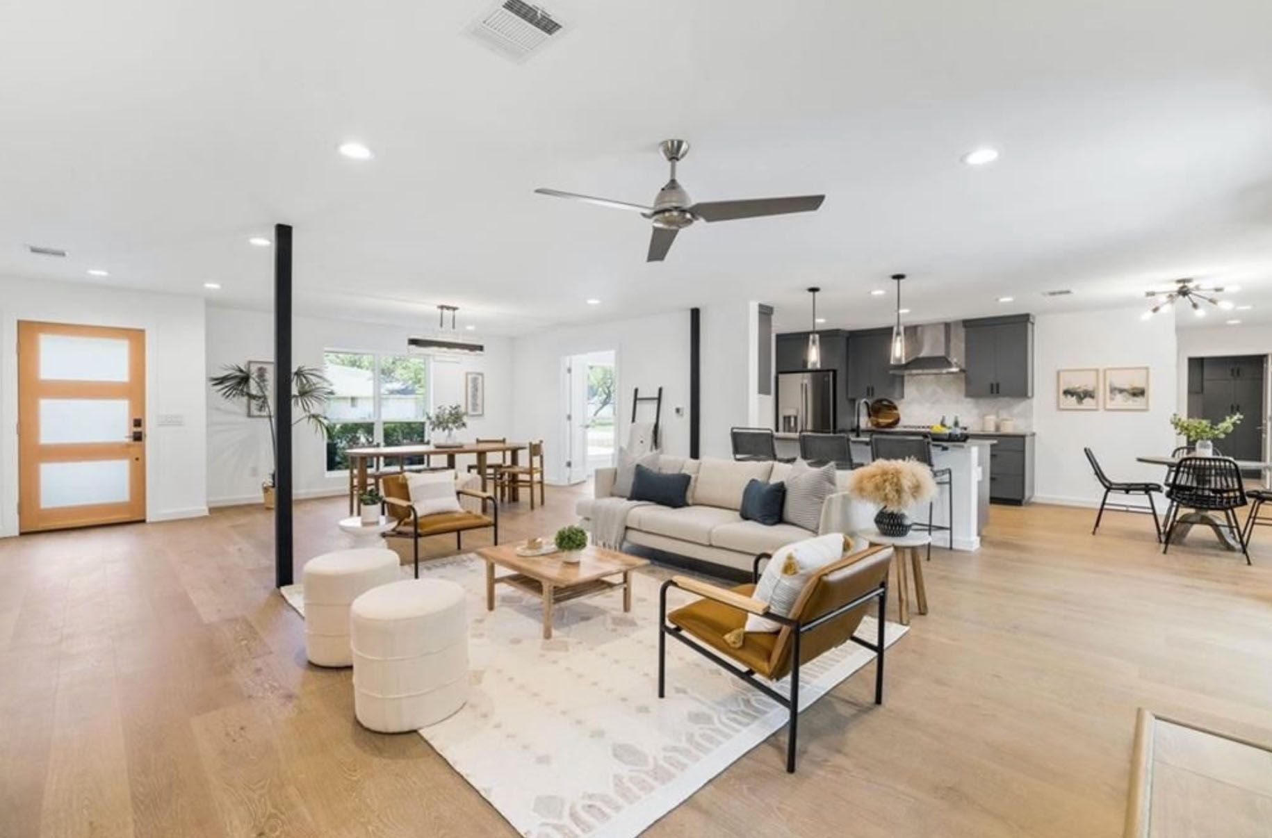 A living room filled with furniture and a ceiling fan.