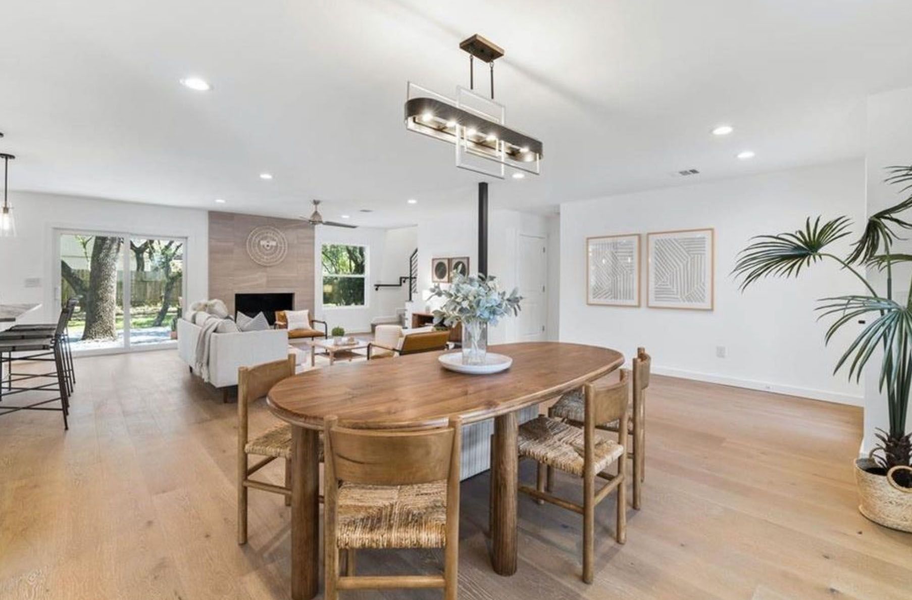 A dining room with a wooden table and chairs in a house.