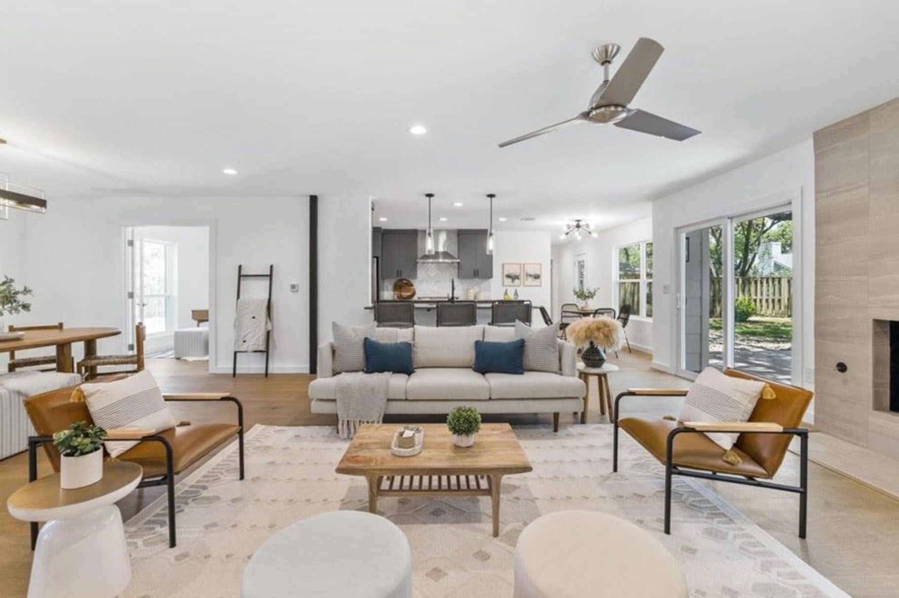 A living room filled with furniture and a ceiling fan.