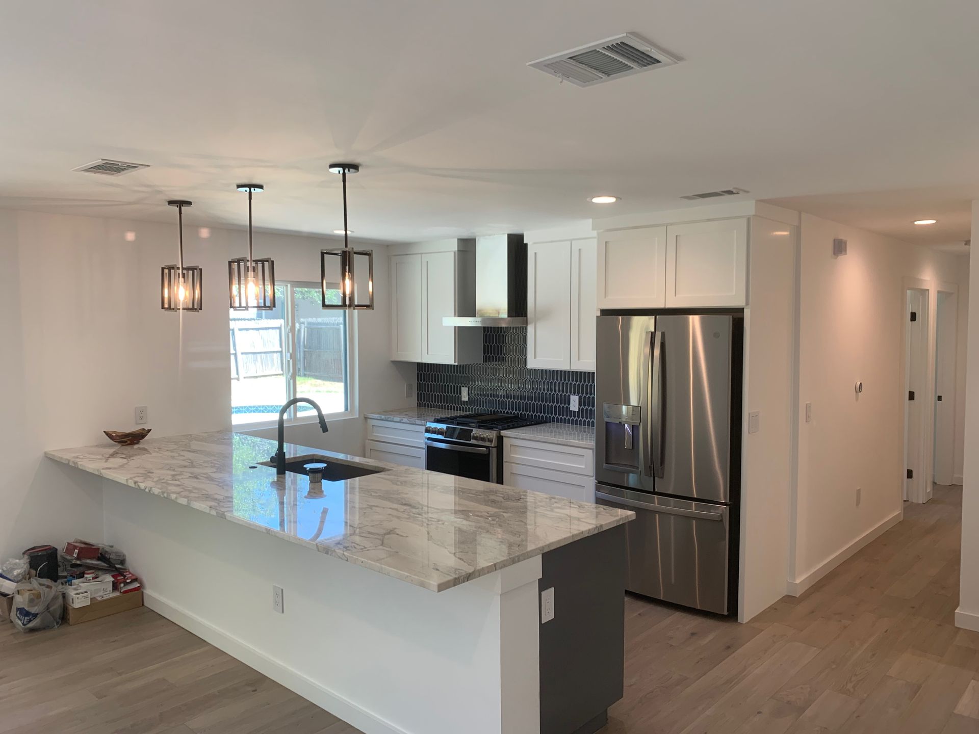 A kitchen with stainless steel appliances and granite counter tops.