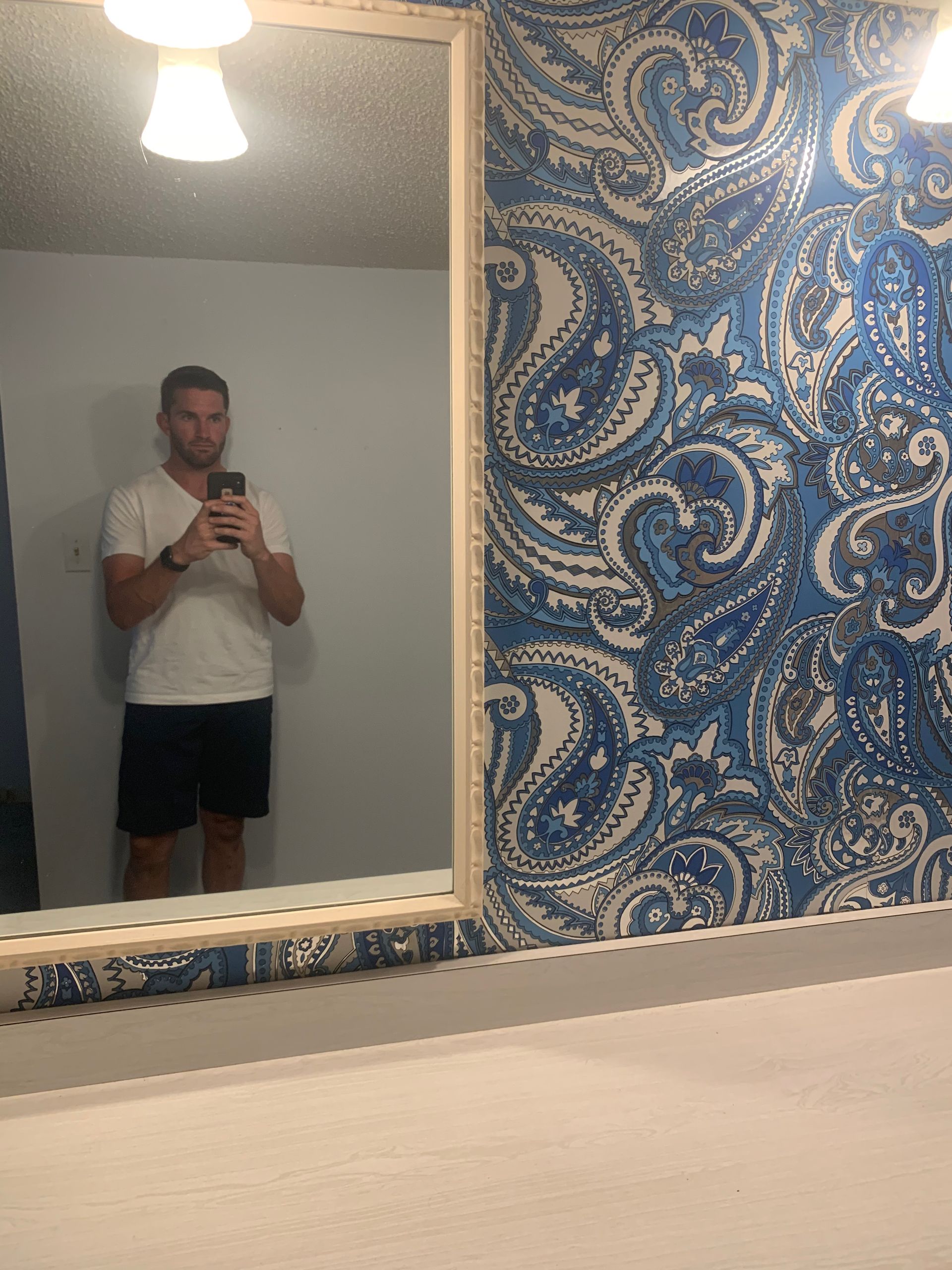 A man is taking a picture of himself in a bathroom mirror.