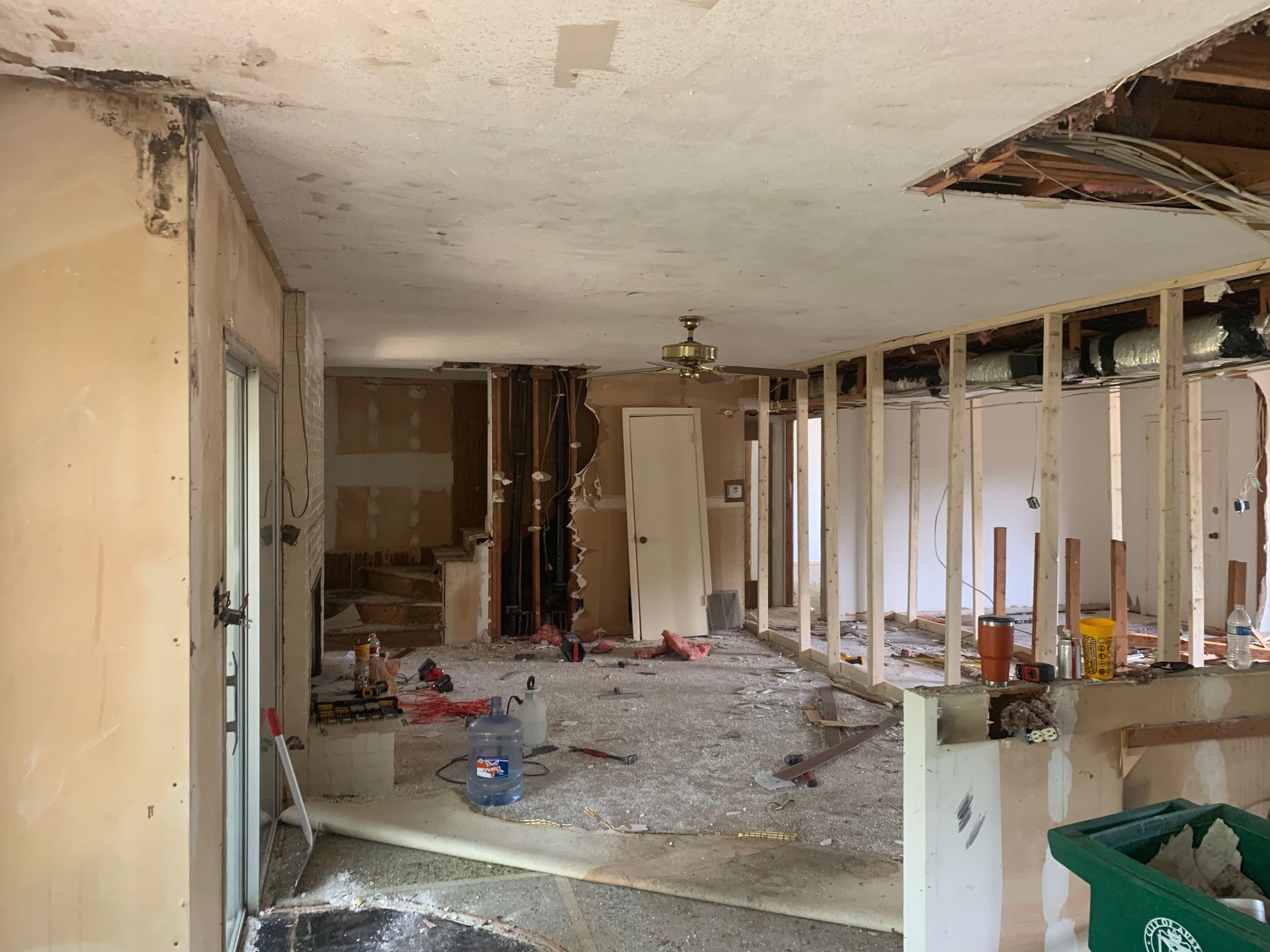 A room that is being remodeled with a ceiling fan.