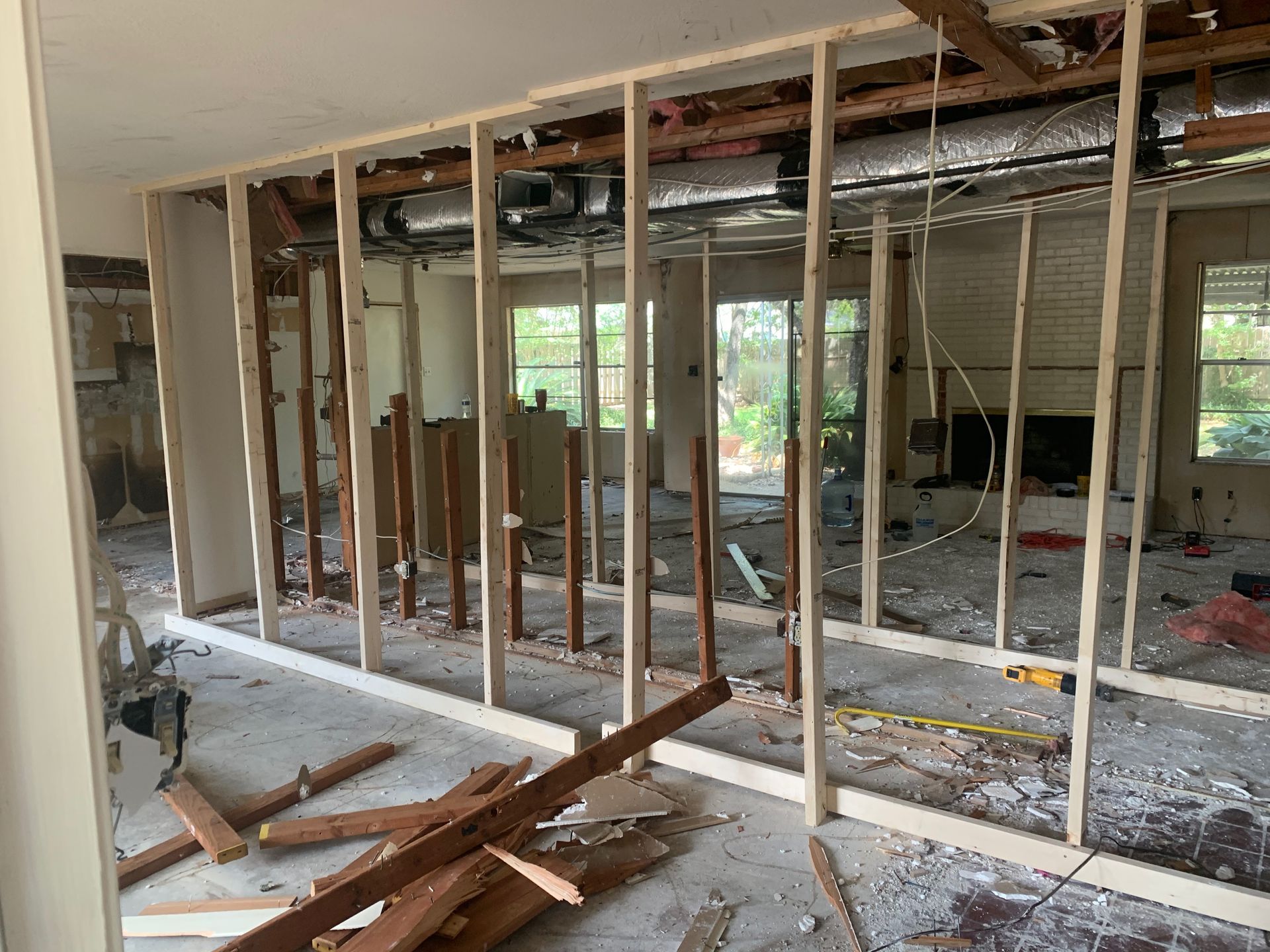 A room with a lot of wood in it is being remodeled.