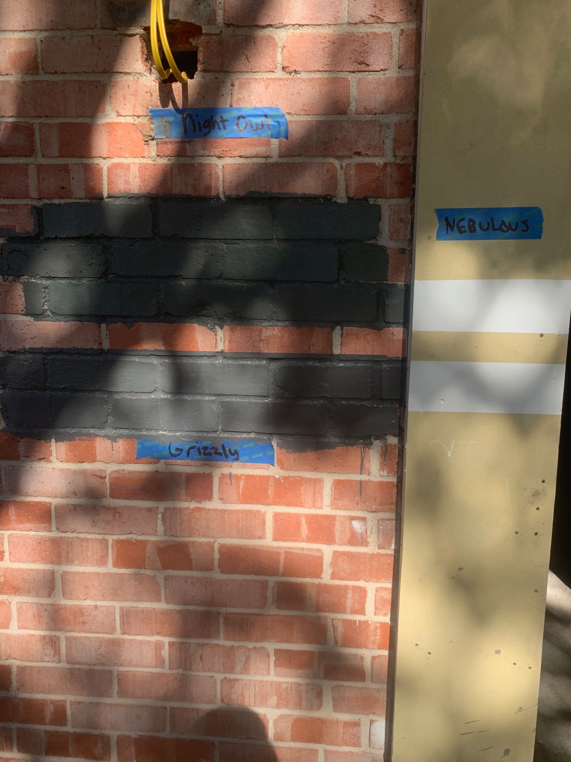 A close up of a brick wall with tape on it.