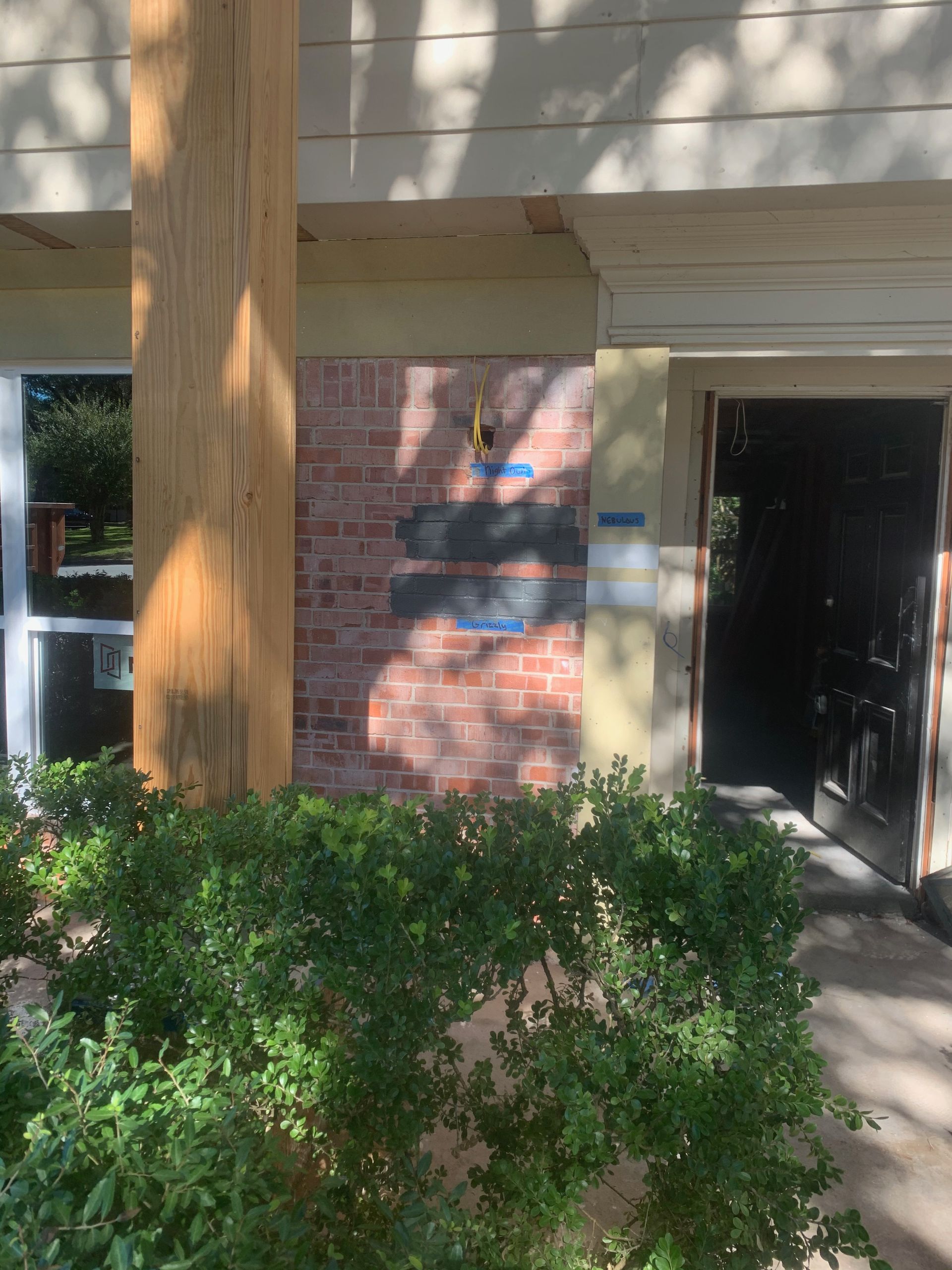 A brick building with a wooden post in front of it.