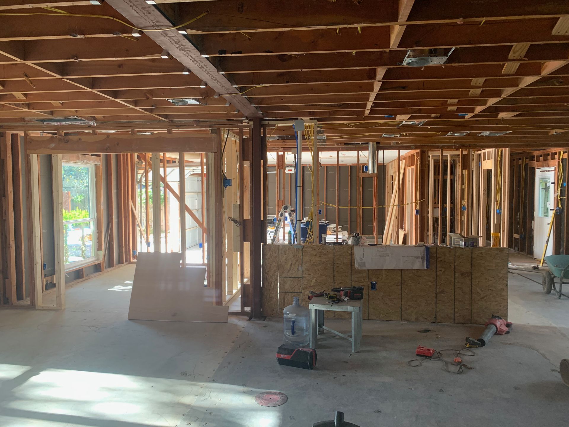 The inside of a building under construction with a lot of wooden beams.