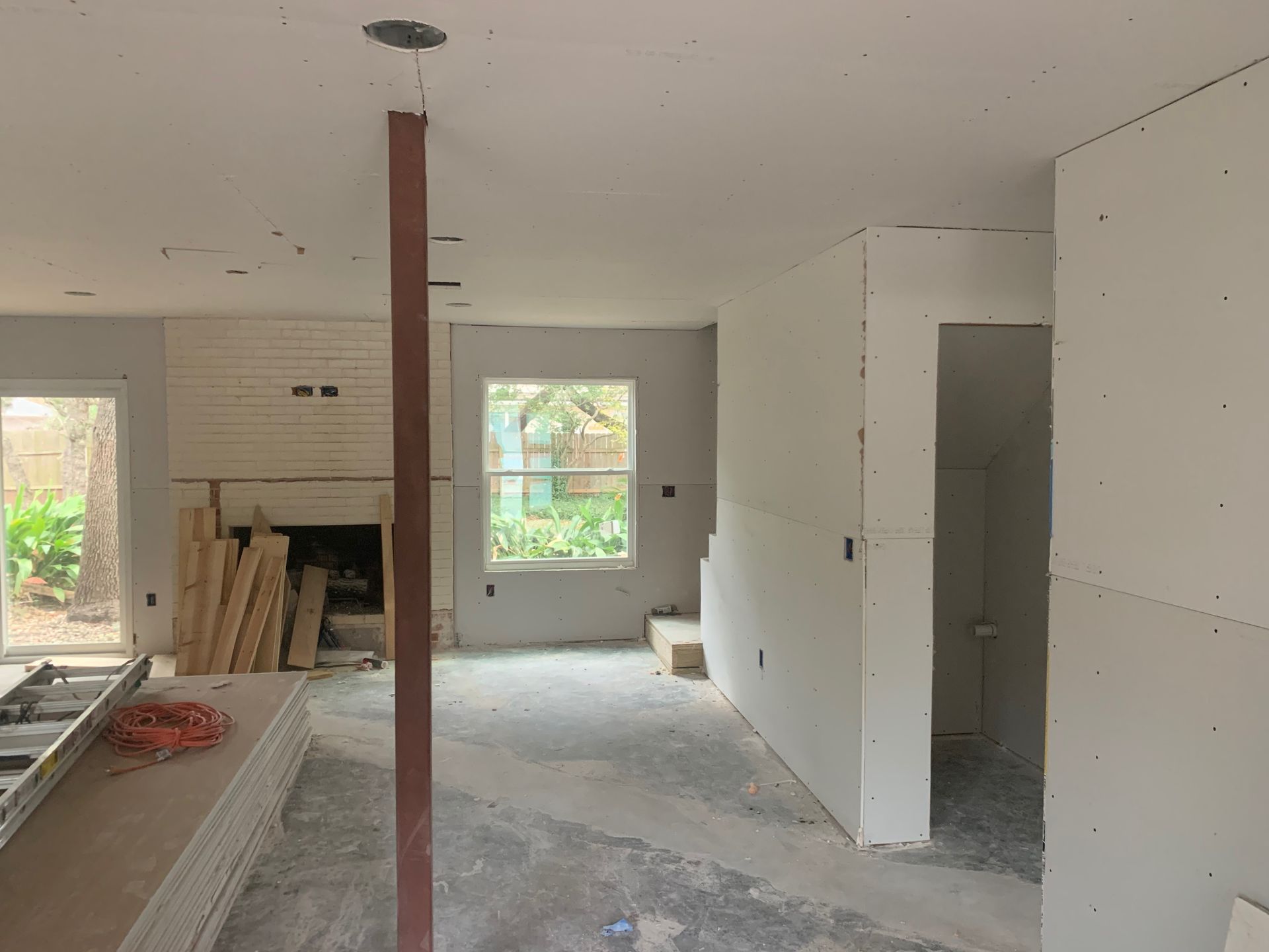 A room that is being remodeled with drywall on the walls.