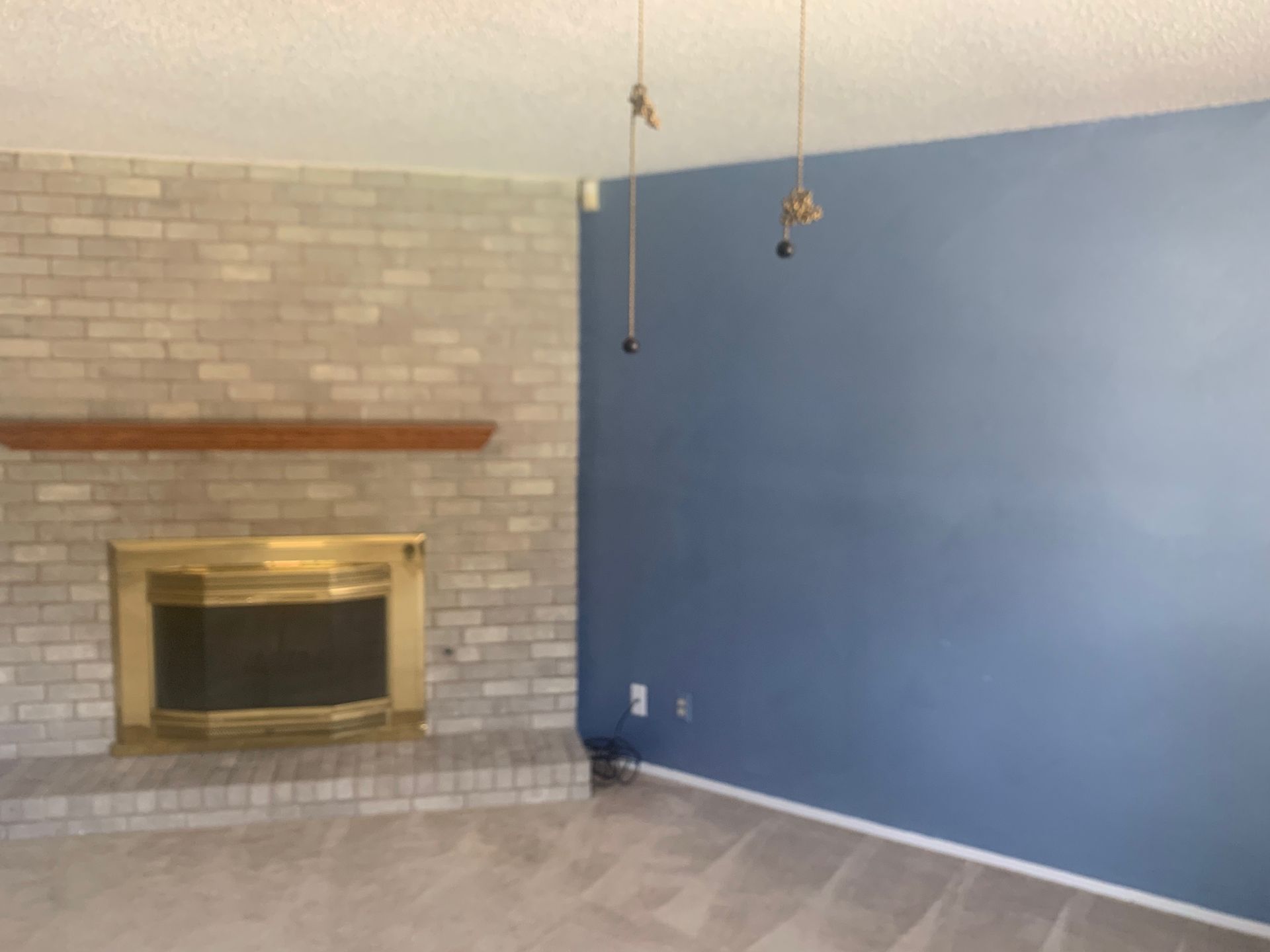 A living room with a fireplace and blue walls.