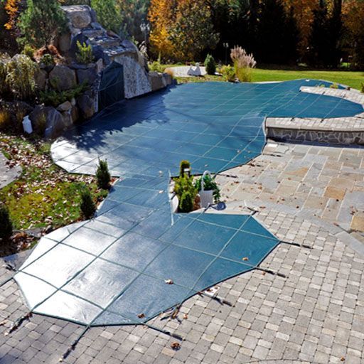 A swimming pool with a blue cover on it