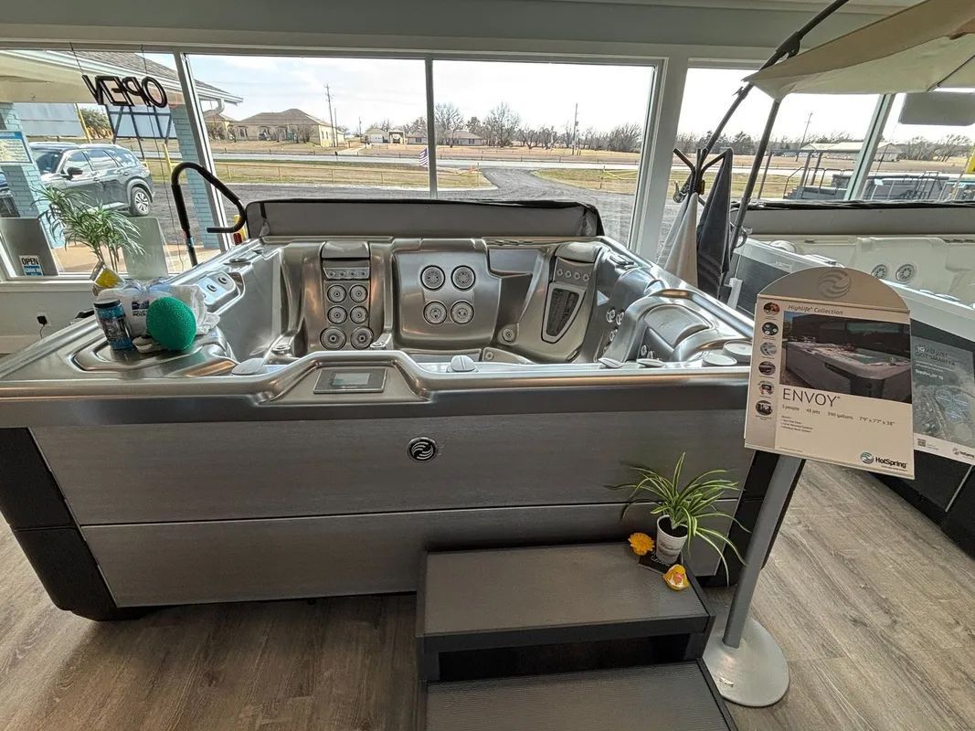 A large stainless steel hot tub is sitting in a showroom.