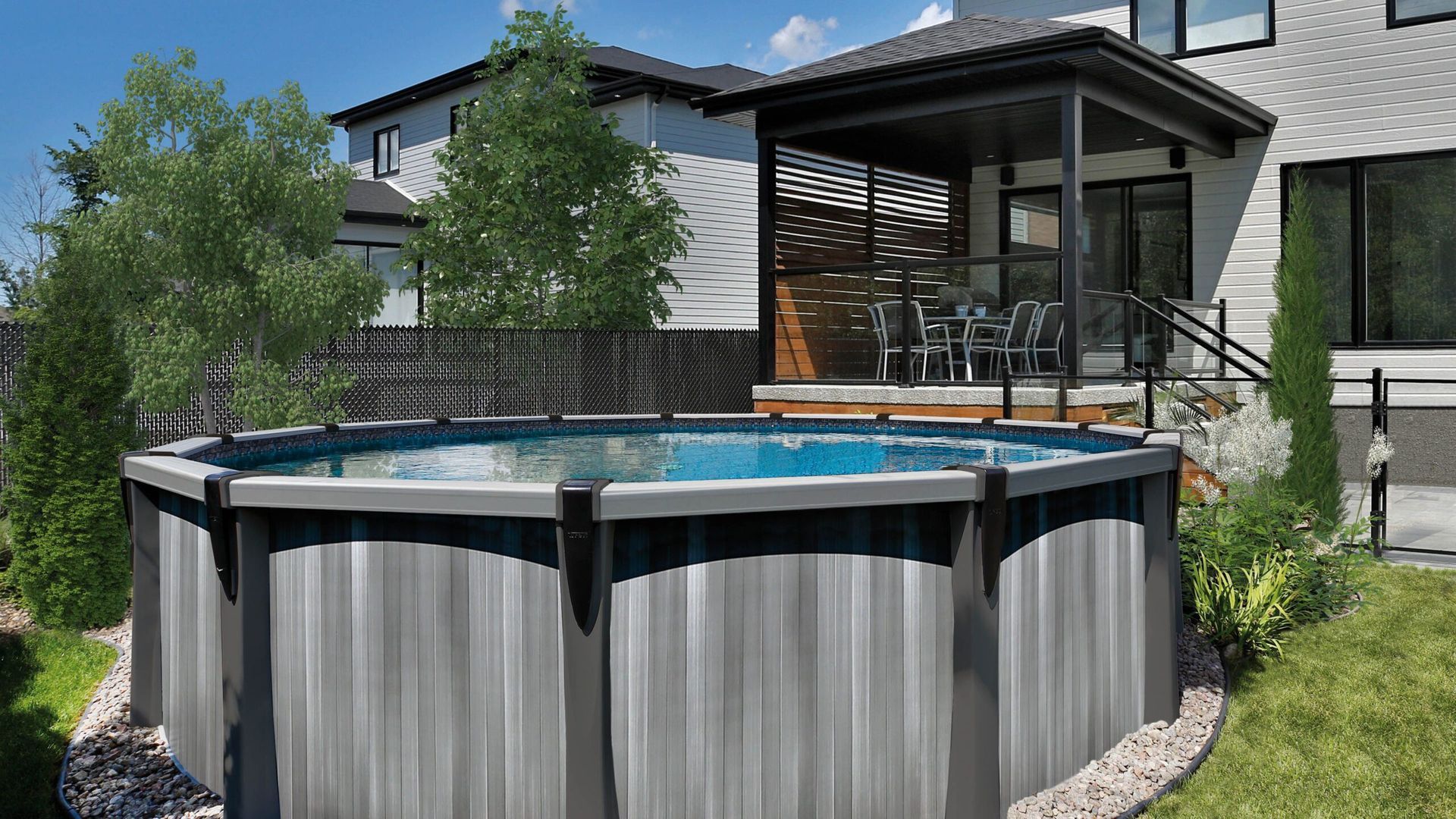 A large swimming pool is in the backyard of a house.