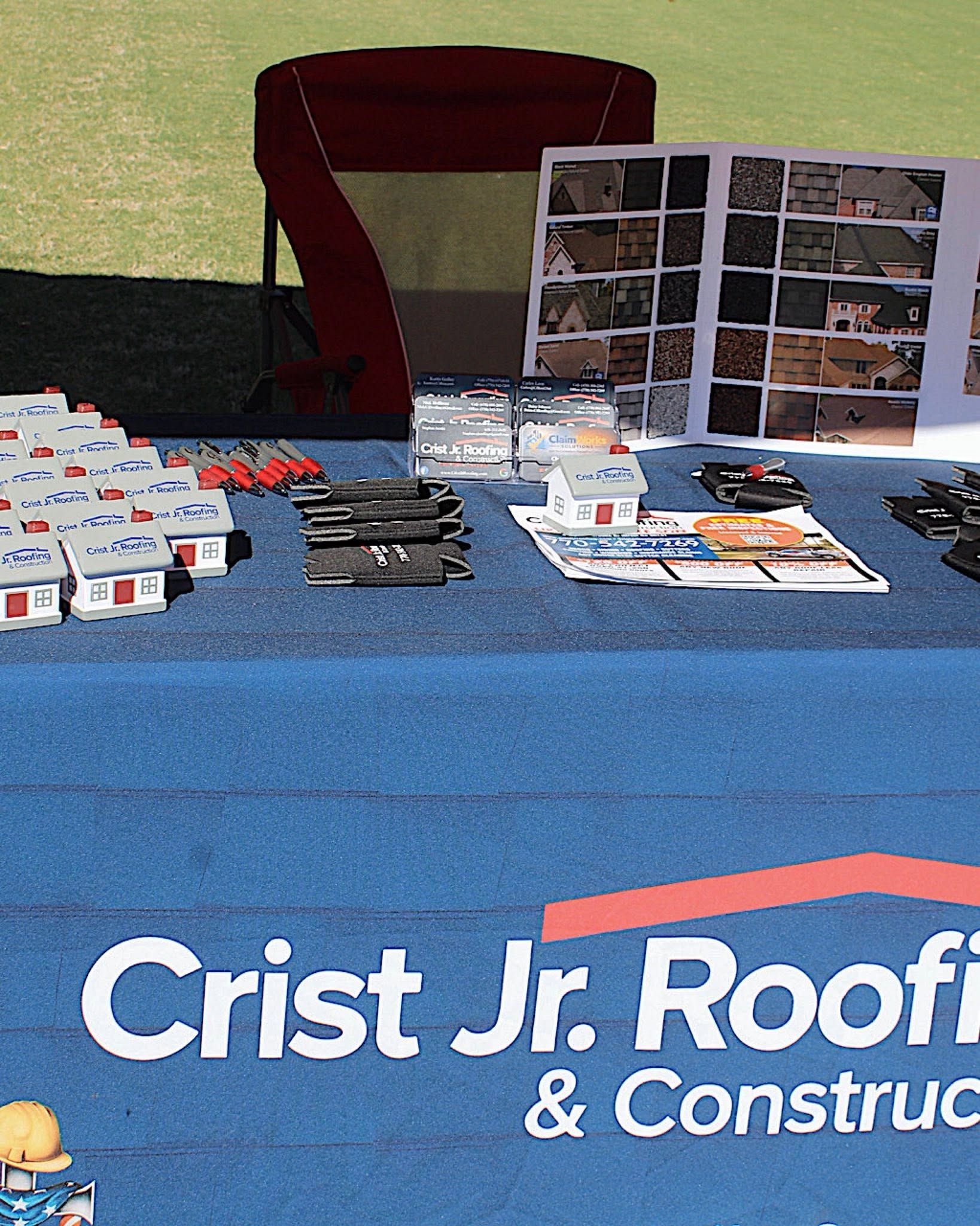 Information table with brochures and display boards for Crist Jr. Roofing & Construction