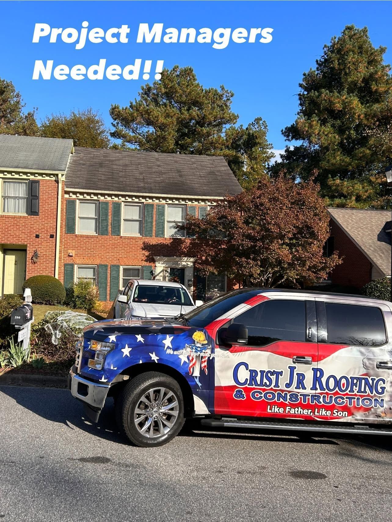 Branded roofing company car parked in front of houses with “Project Managers Needed!!” text