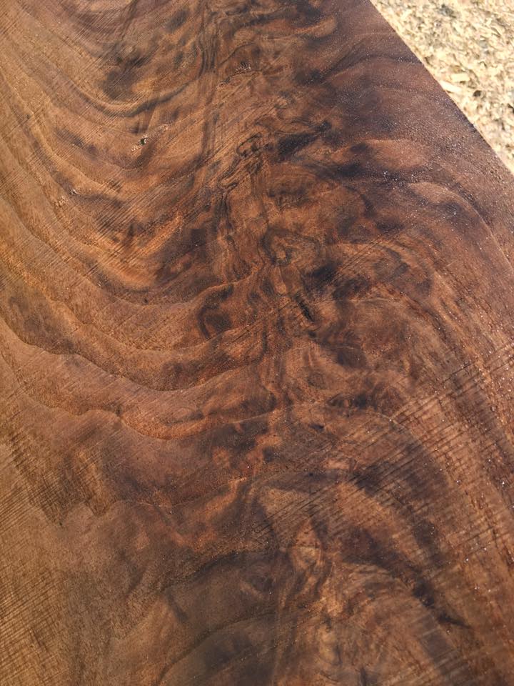 A close up of a piece of wood with a swirl pattern on it.