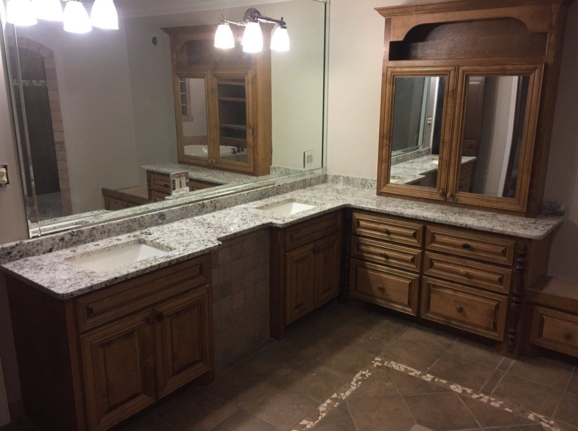 A bathroom with two sinks and a large mirror.