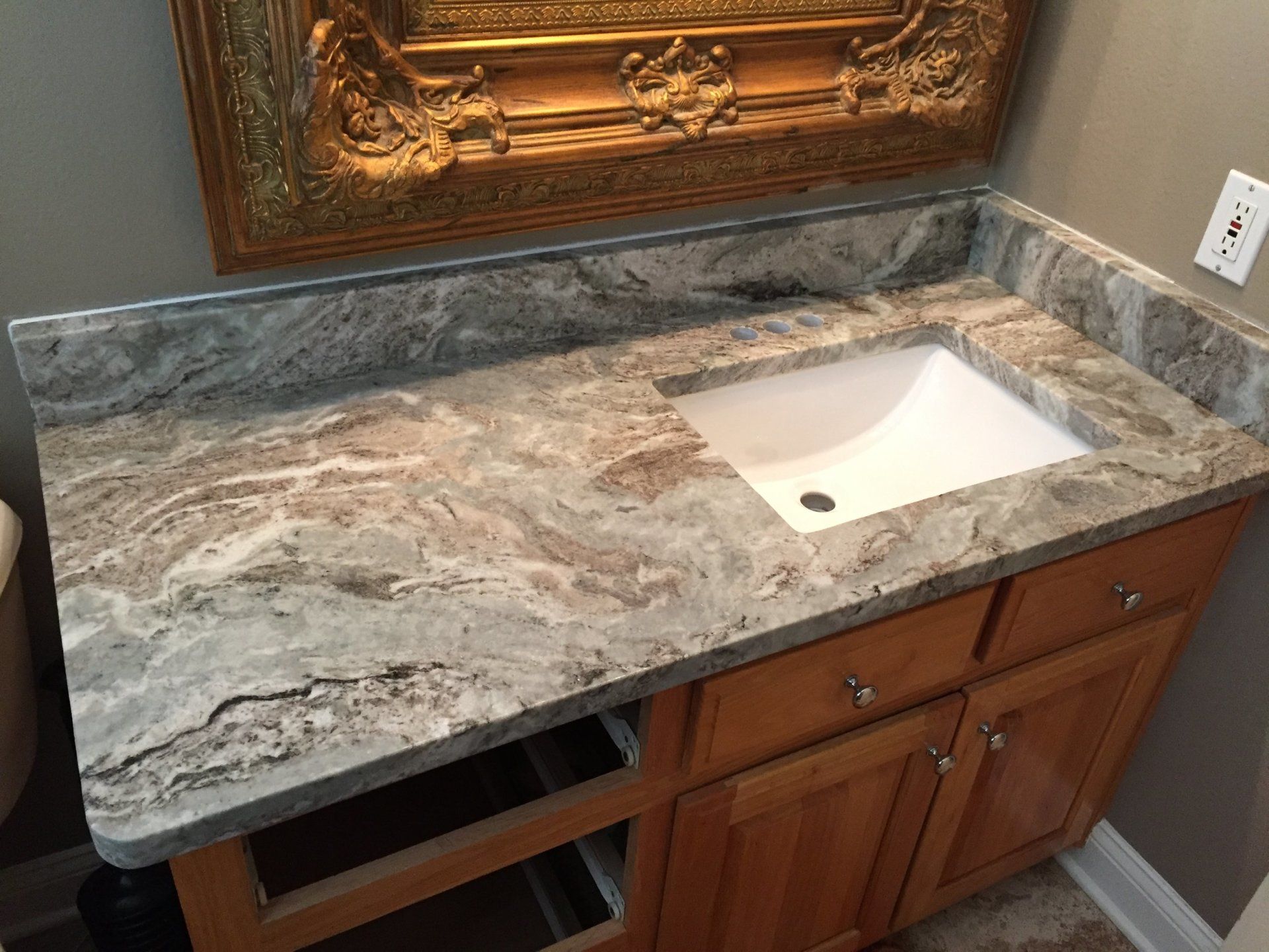 A bathroom vanity with a sink and a mirror.