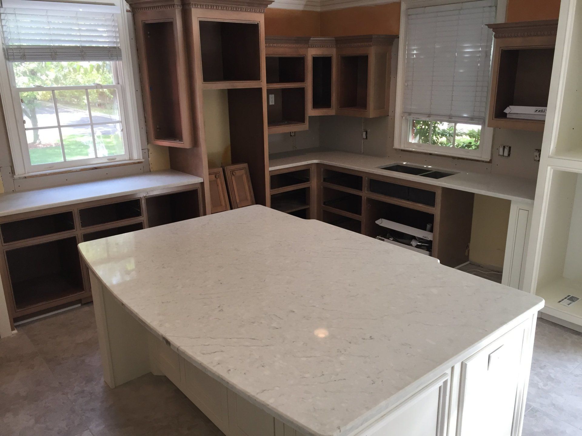 A kitchen under construction with a large island in the middle