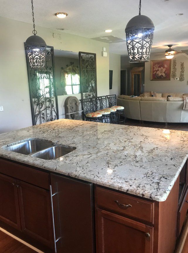 A kitchen with a granite counter top and a sink
