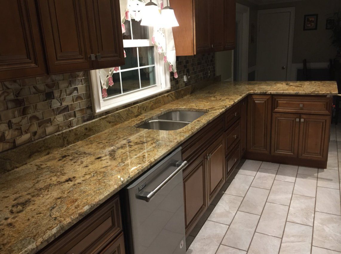 A kitchen with granite counter tops and stainless steel appliances