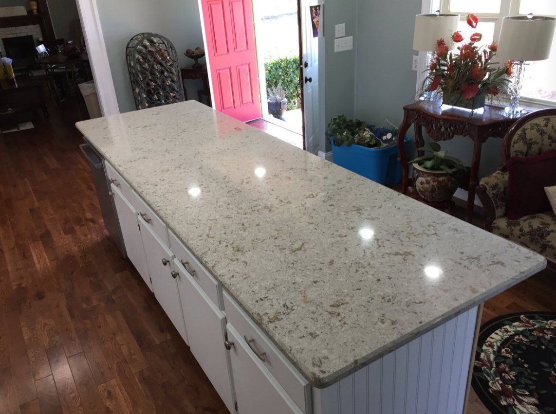 There is a large island in the middle of the kitchen.