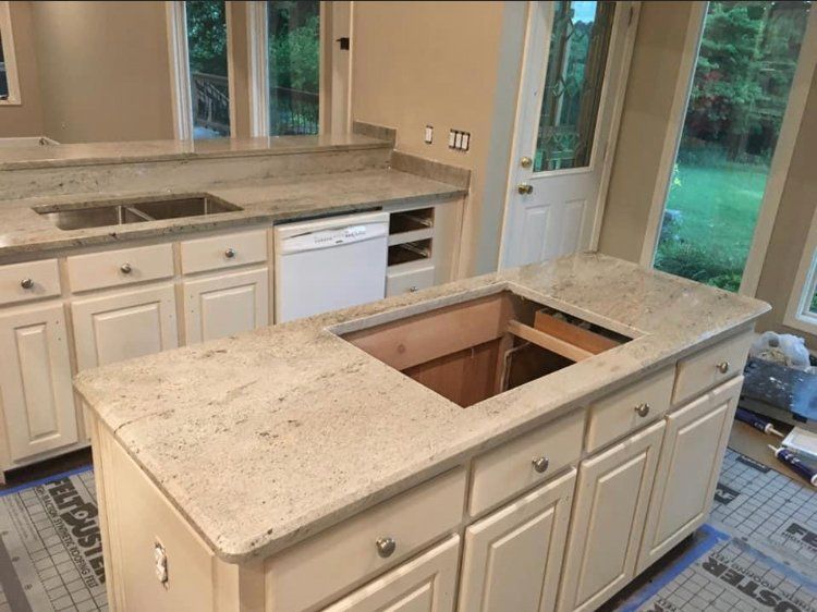 A kitchen with a large island and a sink.
