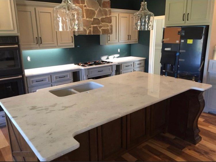 A kitchen with a large island and a sink