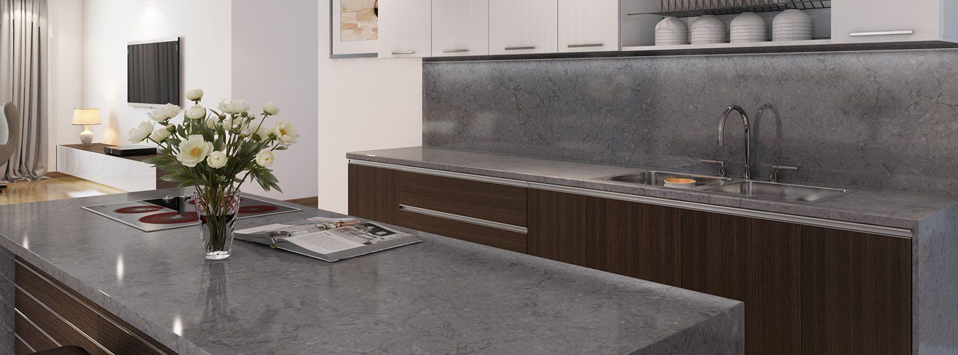 There is a vase of flowers on the counter in the kitchen.