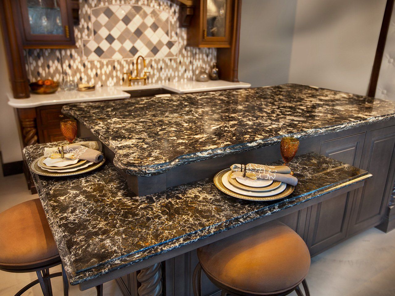 A kitchen with a granite counter top and plates on it.