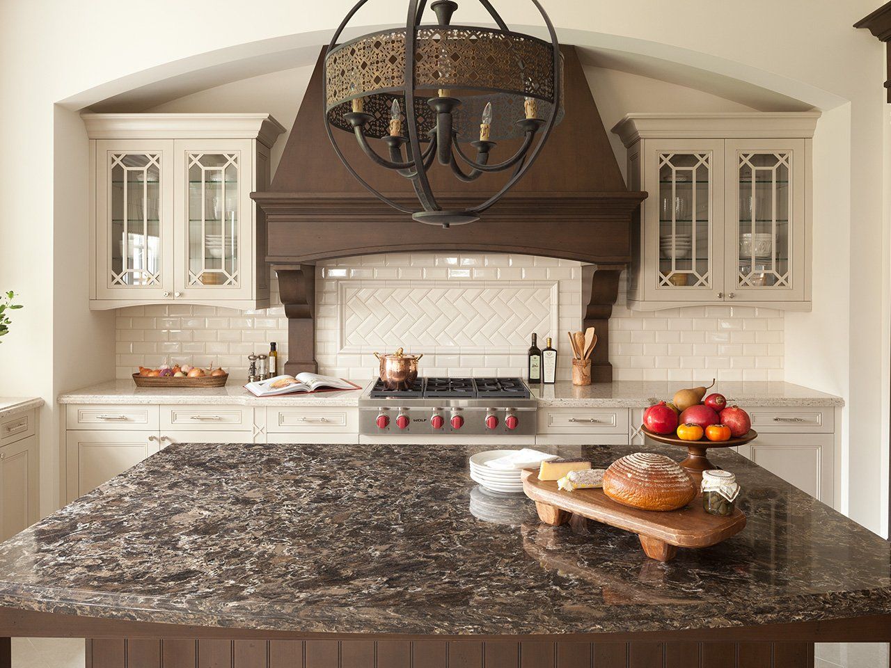 A kitchen with a large island and a stove top oven.