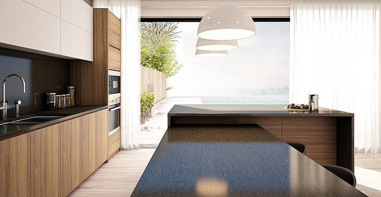 A kitchen with a large island and a large window.