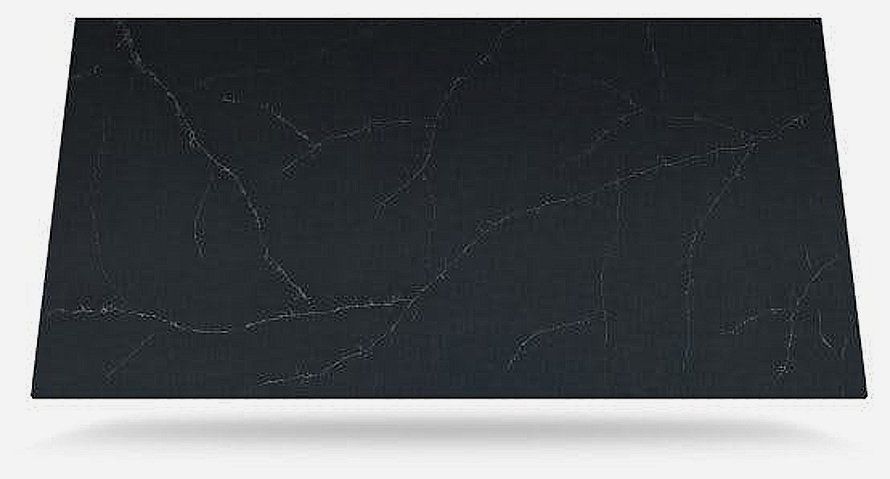 A black granite slab is sitting on top of a white surface.