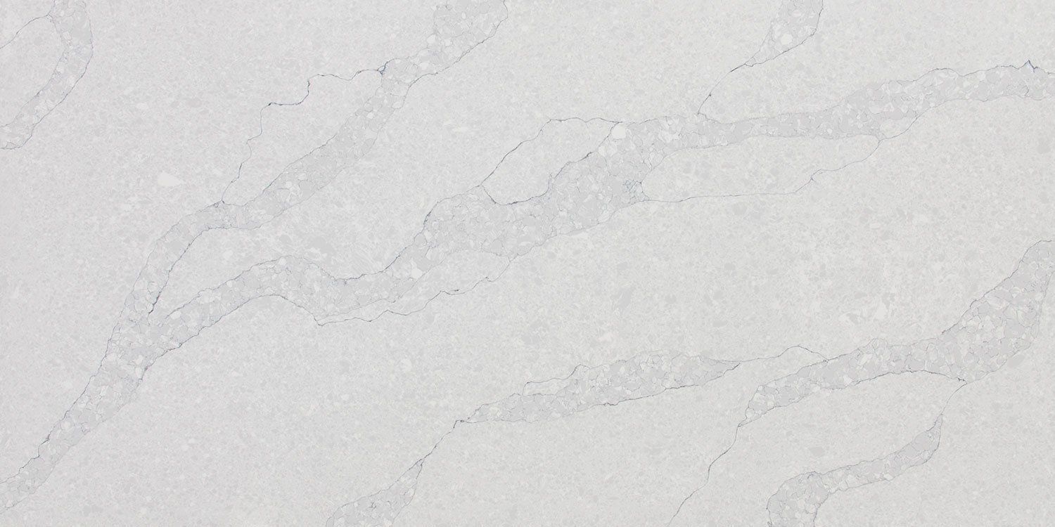 A close up of a white granite counter top.