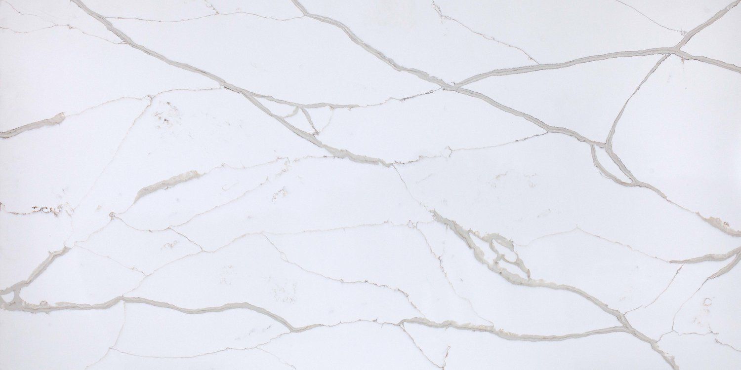 A close up of a white marble counter top.