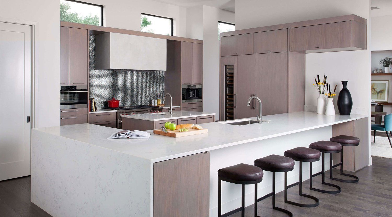 A kitchen with a large island and stools