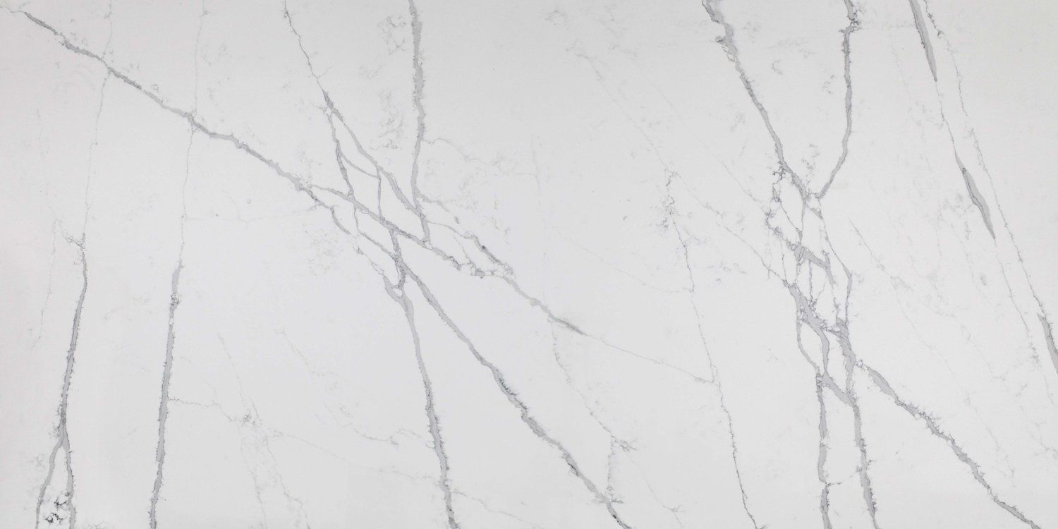 A close up of a white marble slab with gray veins.