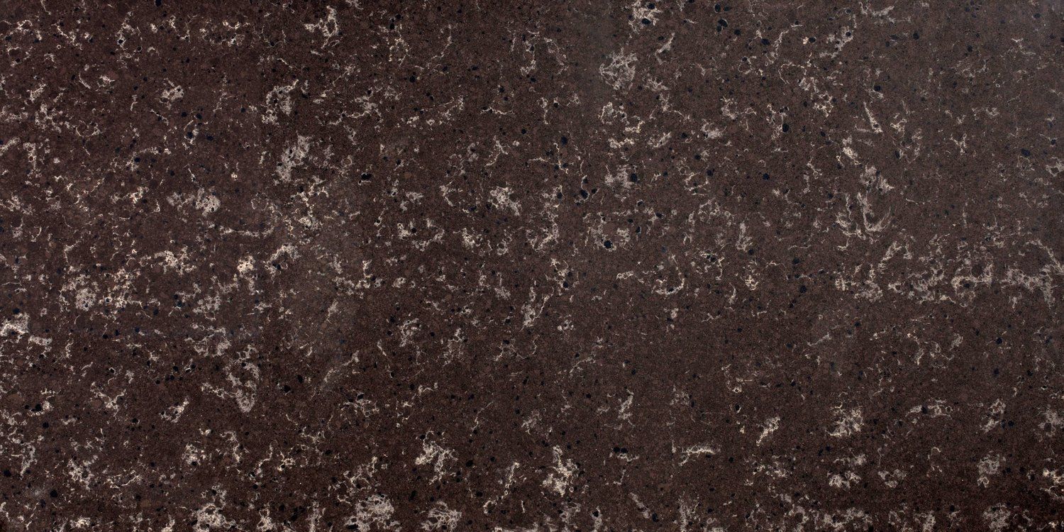 A close up of a brown granite counter top with white spots.