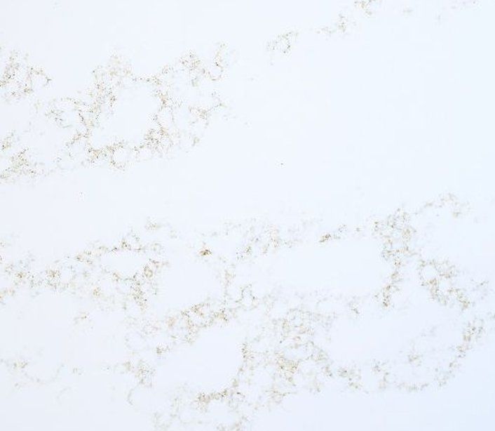 A close up of a white marble counter top with a brown texture.