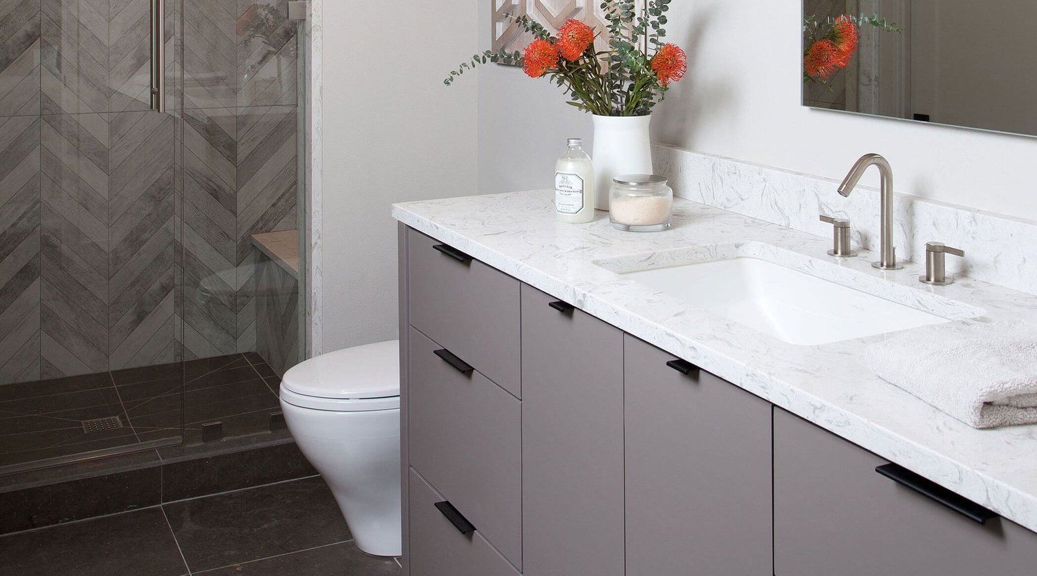 A bathroom with a sink , toilet and shower.