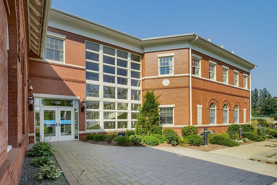 Red brick building with large glass windows.