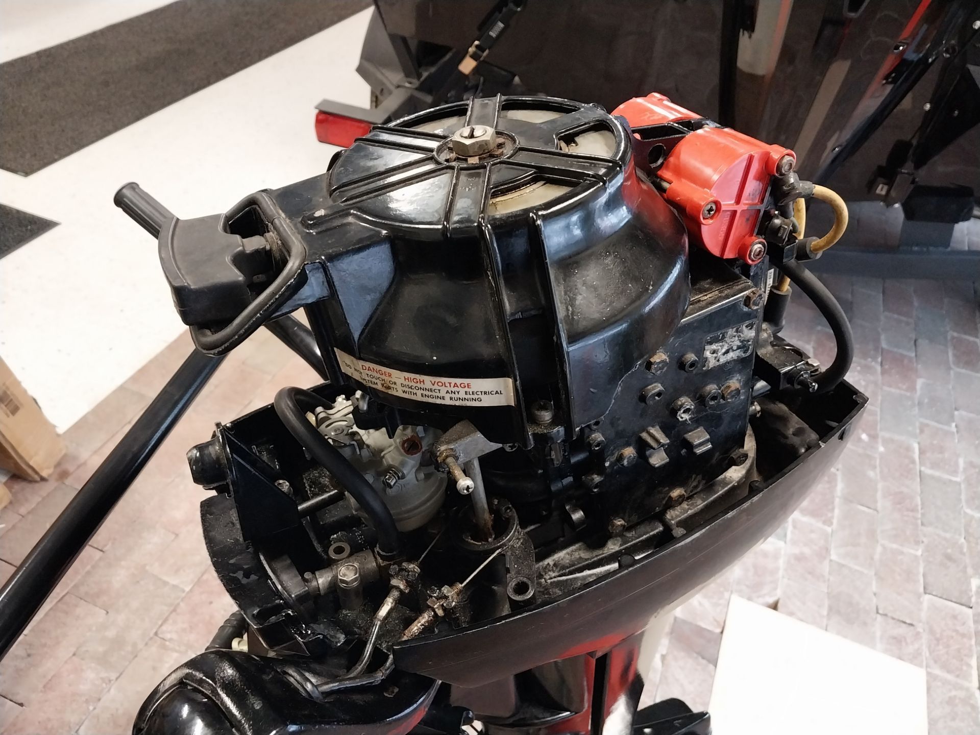 Black outboard motor, front view. Engine components visible.