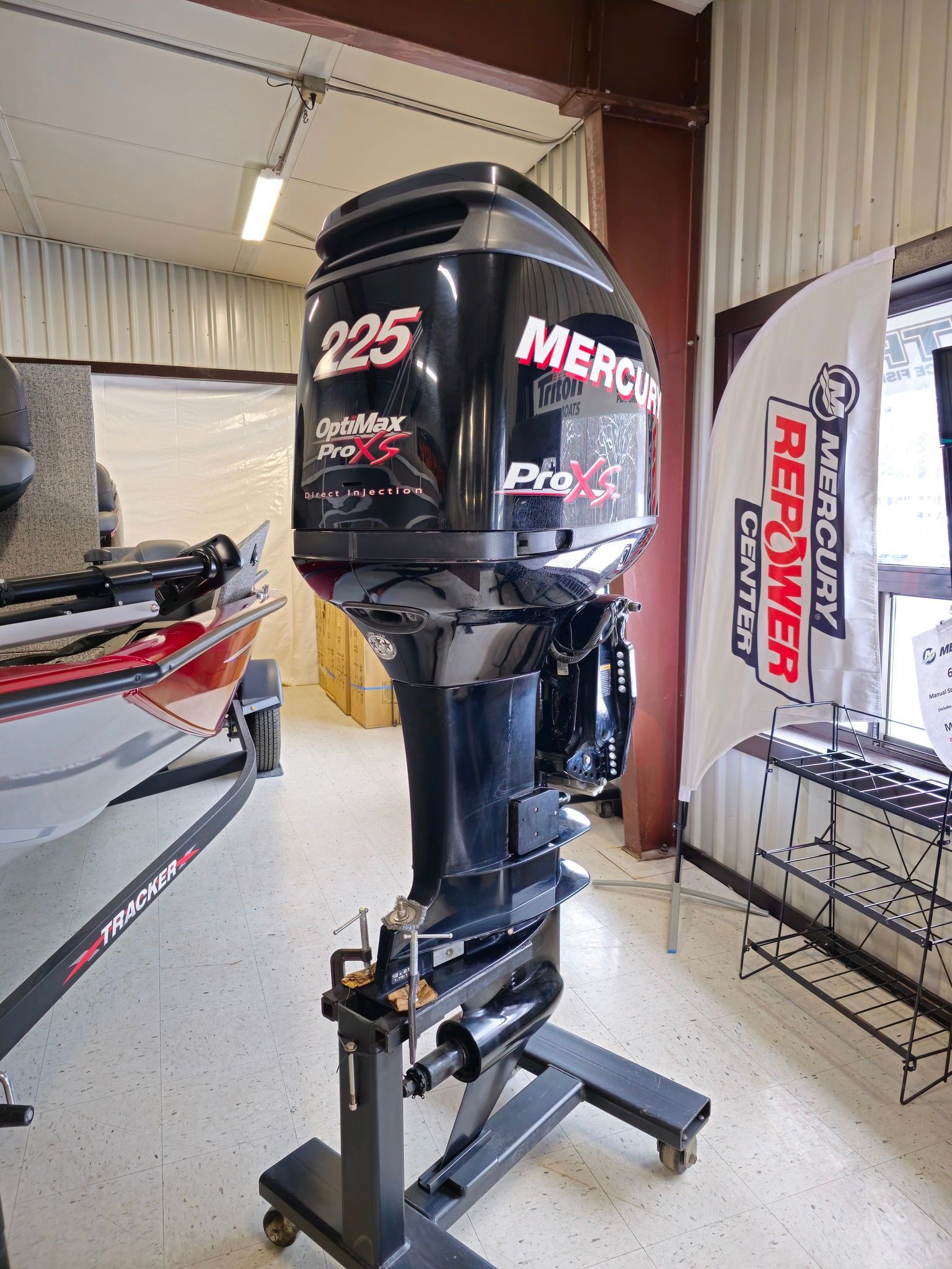 Mercury Pro XS 225 outboard motor on a stand in a showroom.