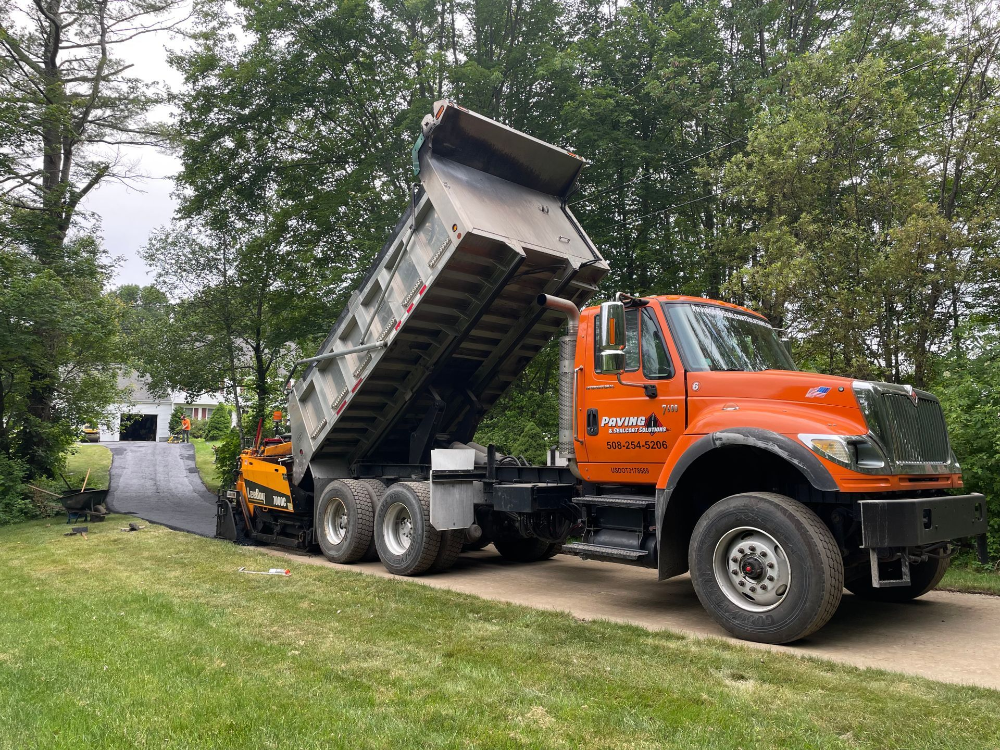 A dump truck is parked on the side of a road.