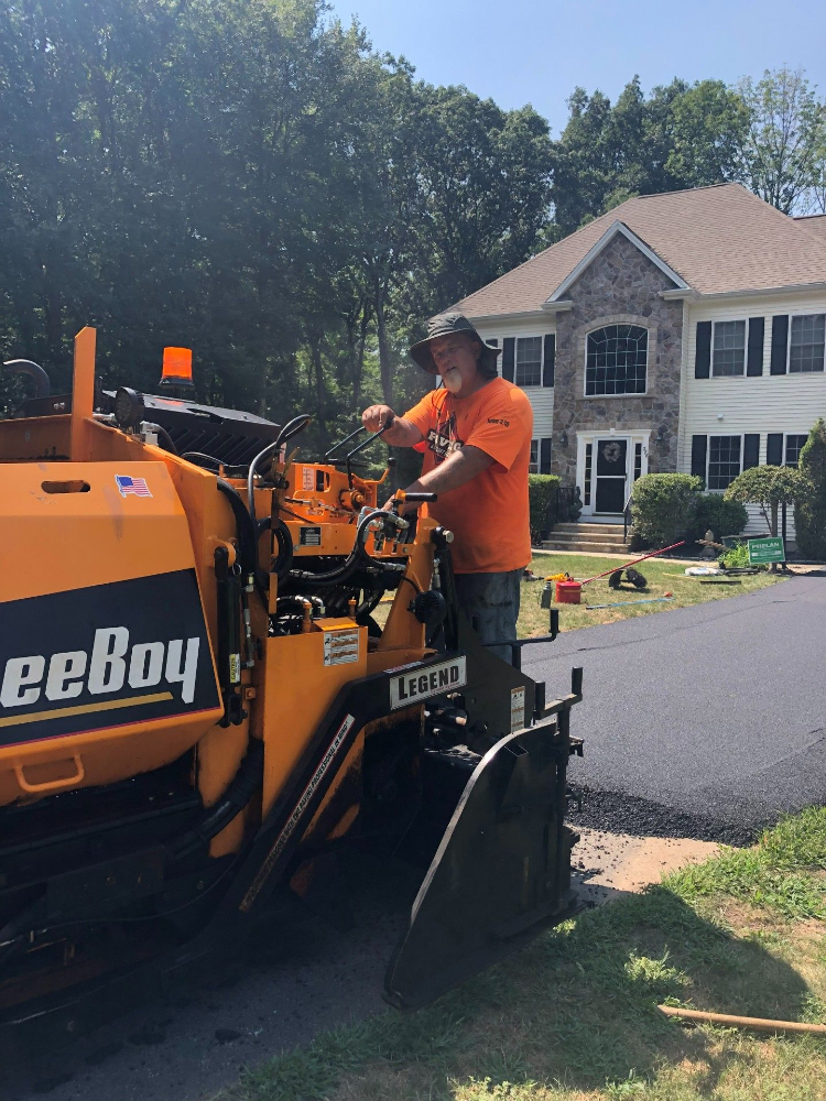 A man is standing next to a machine that says ' eeboy ' on it