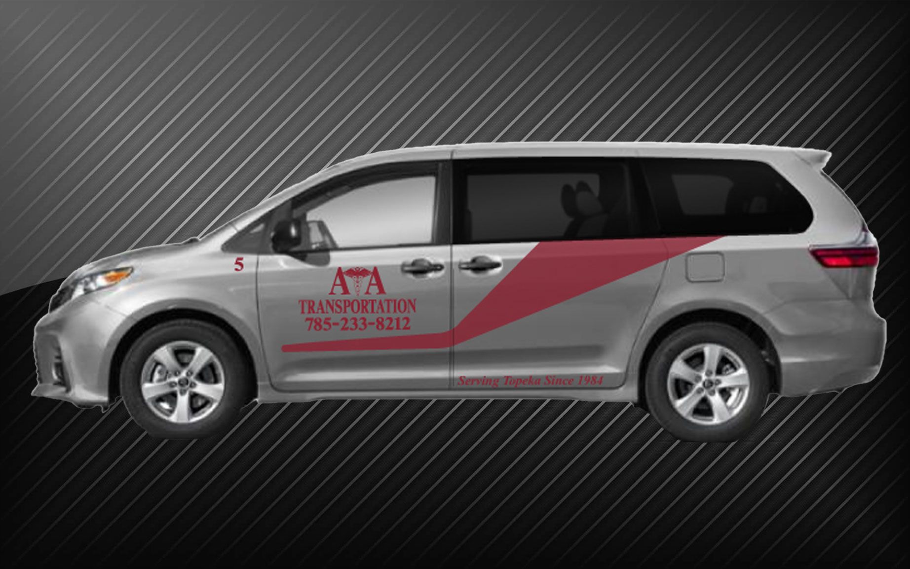 A silver minivan with the word ata on the side