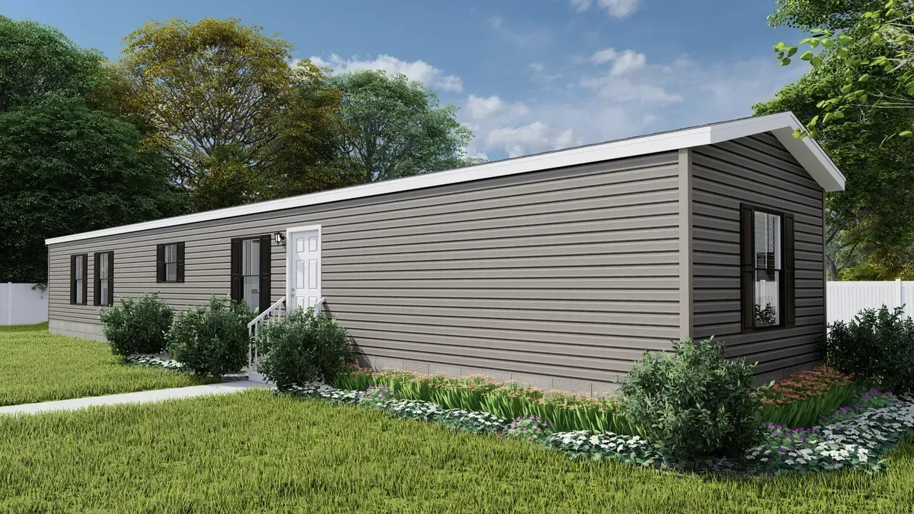 A light gray and dark gray manufactured home with a white door and black window frames, set on a grassy lawn.
