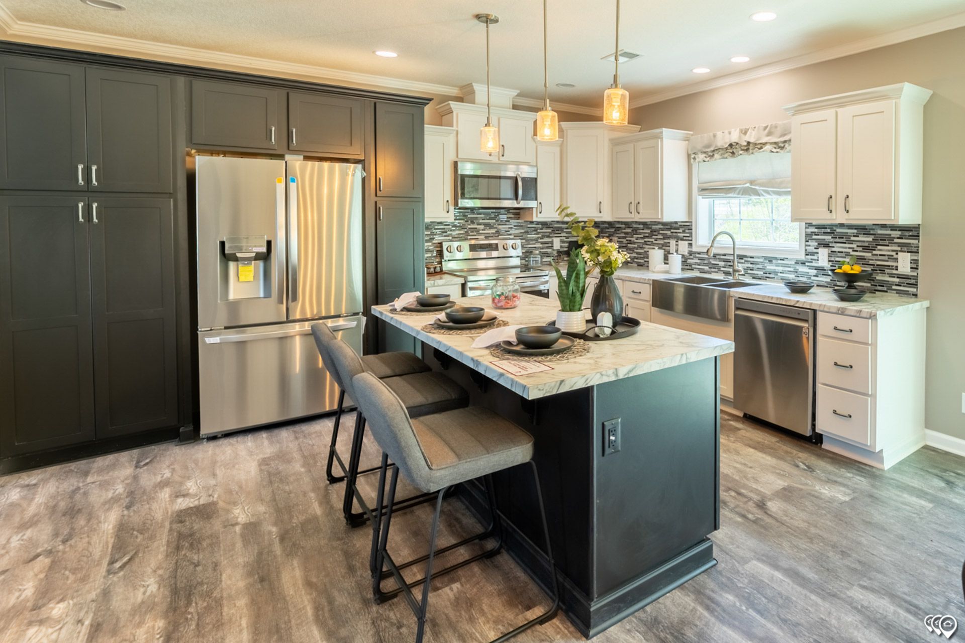 A kitchen with stainless steel appliances and a large island.