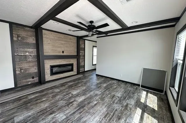 A living room with a fireplace and a ceiling fan.