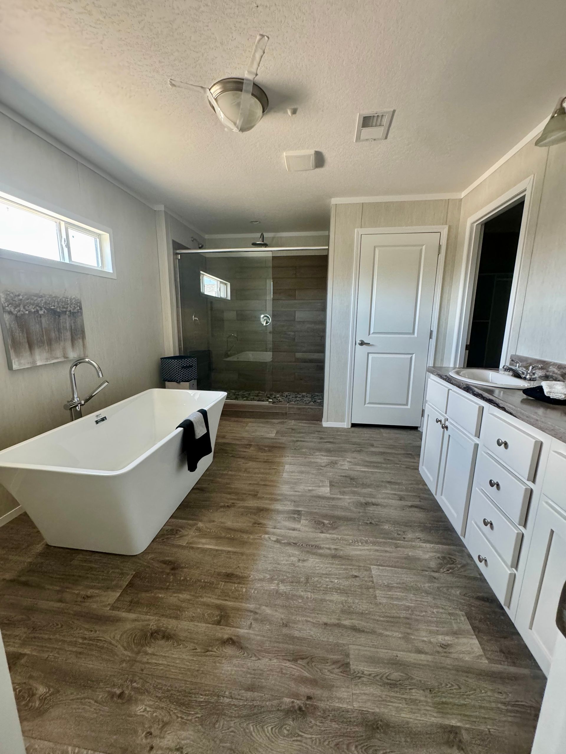 A bathroom with a bathtub and a walk in shower.