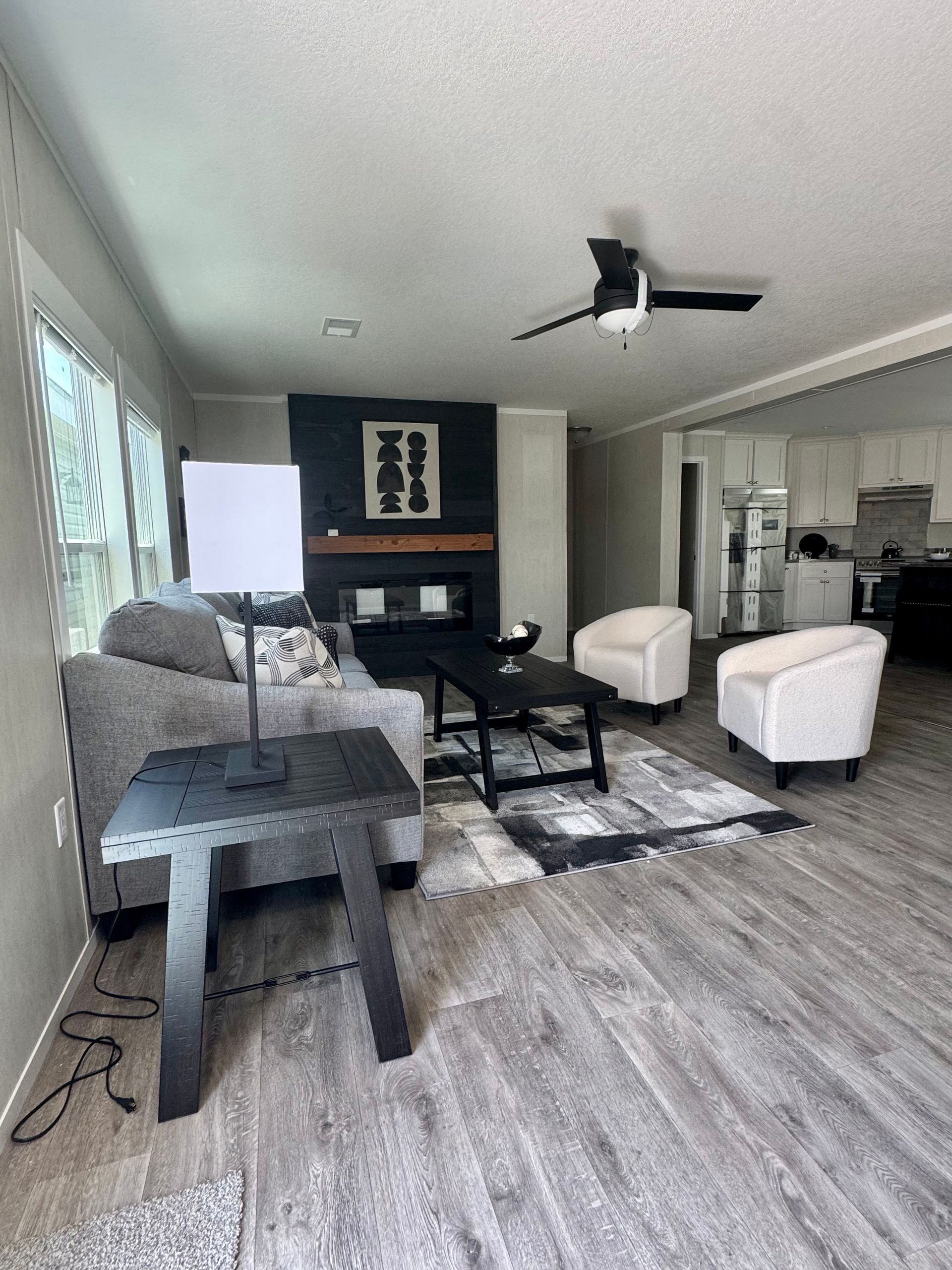 A living room filled with furniture and a ceiling fan.