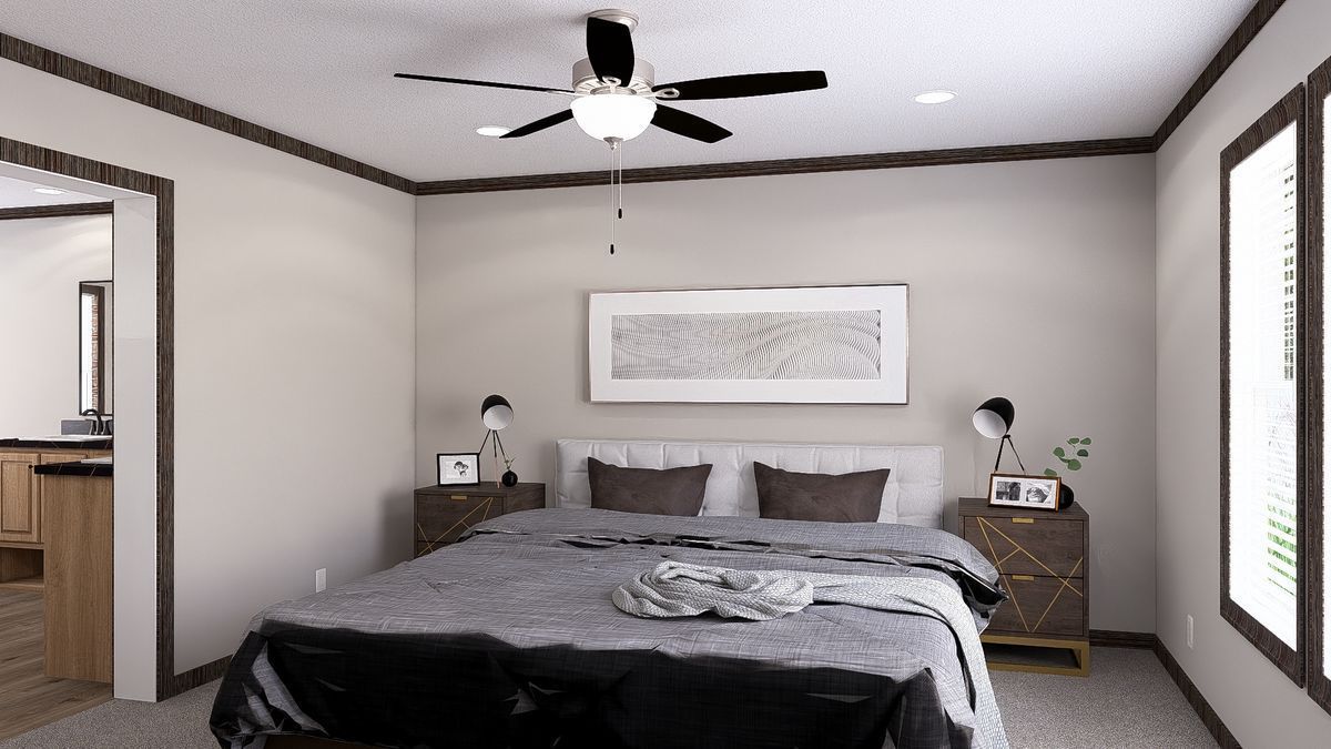A bedroom with a large bed and a ceiling fan.